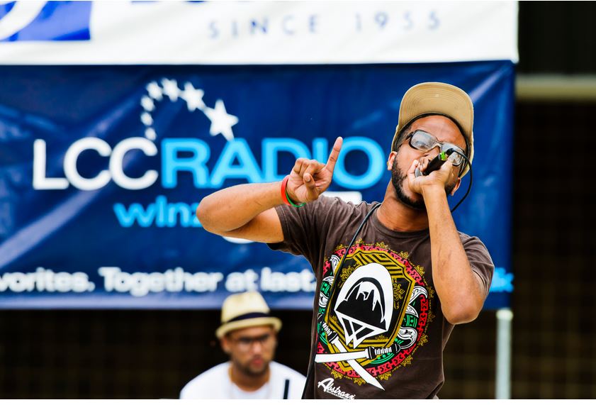 Local rap artist, Philthy, performing with LCC Radio sign in background.