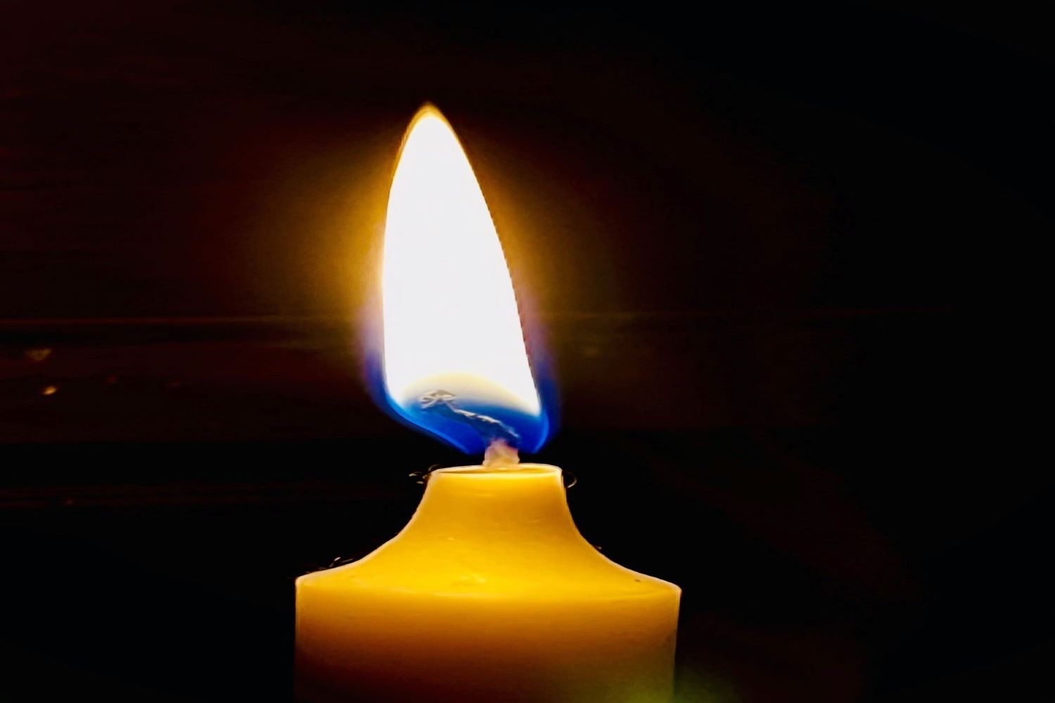 Photo of a lit candle