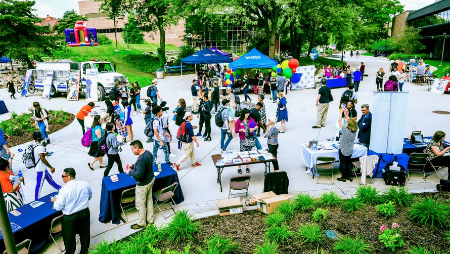 People gathered outside on LCC's campus- for a summer resource fair.