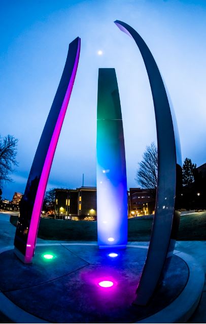 LCC Upward Bound sculpture is lit in the evening displaying bright colors