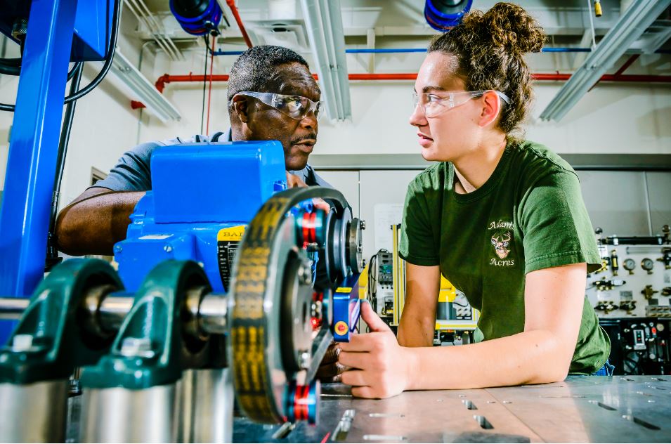 Black instructor with whilte student in front of a lathe machine in LCC's Tech Careers building.