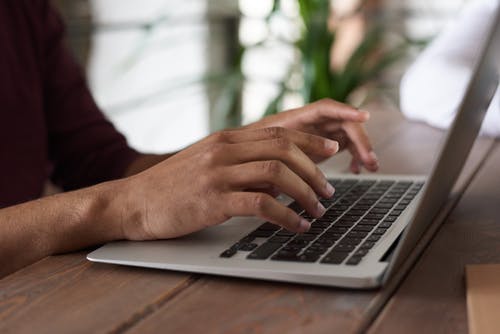 Hands on a computer keyboard.