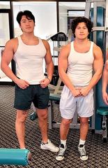 Asher and Sage, young Asian/American men wearing white tshirts, in a gym