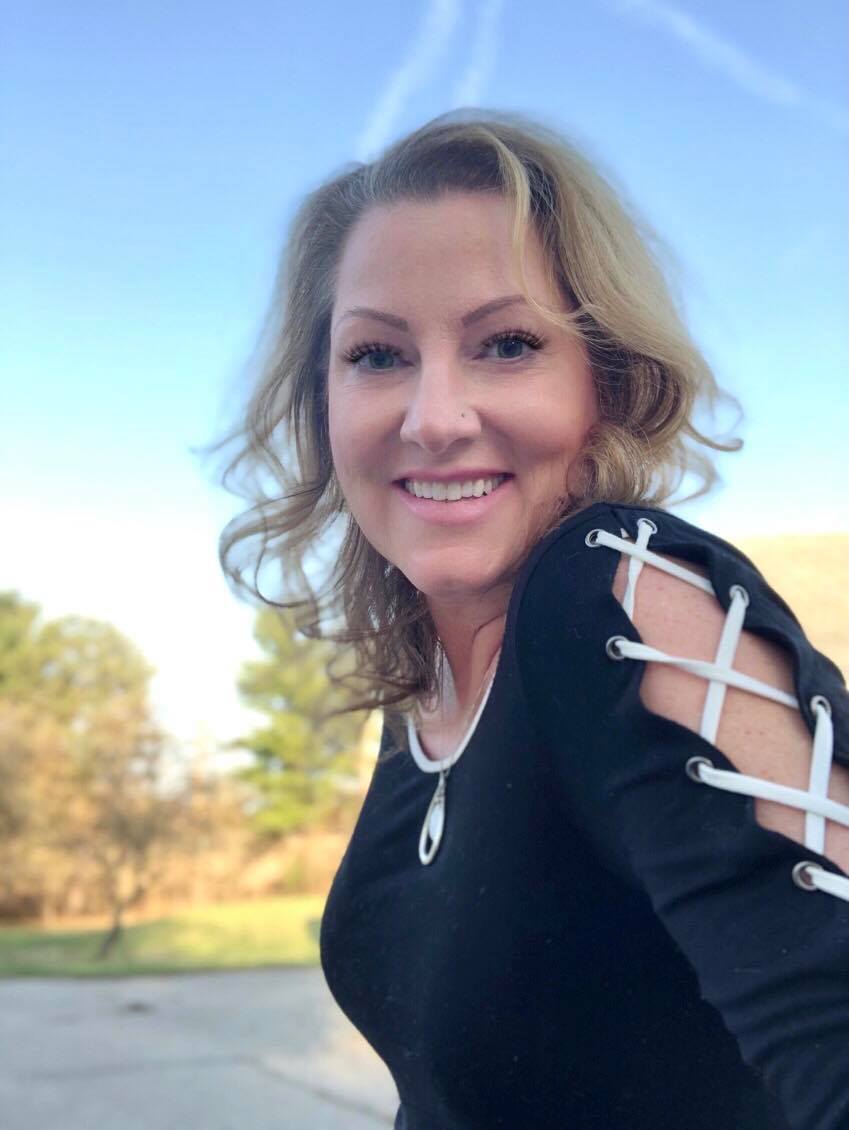 Megan Lin, white woman, outdoors wearing a black shirt.